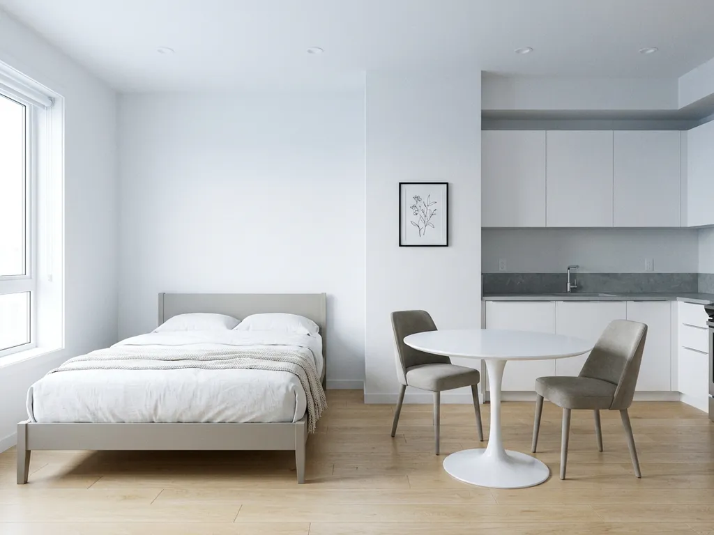 Minimalistisch eingerichtetes Apartment mit graubeigem Bettgestell, rundem Tulpen-Esstisch und hellem Eichenparkett.