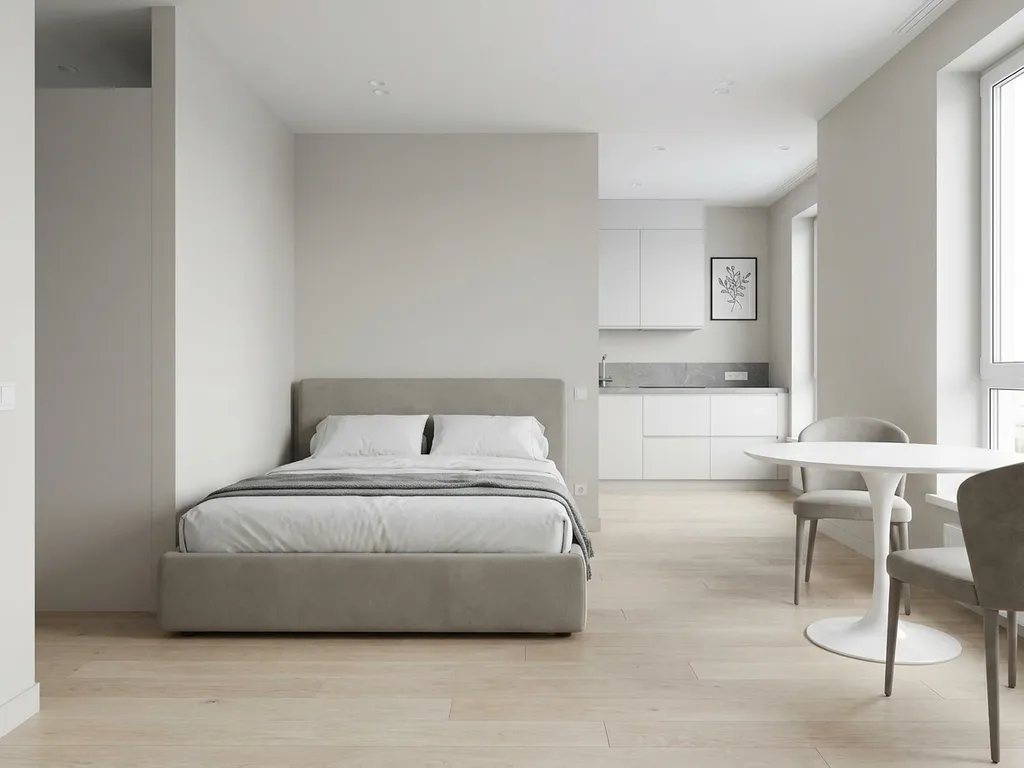 Minimalistisch eingerichtetes Apartment mit greigem Bettgestell, rundem Tulpen-Esstisch und hellem Eichenparkett.