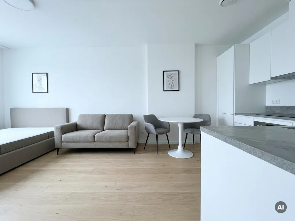 Minimalistisch eingerichtete Wohnung mit greigem Bettgestell, Tulpen-Esstisch, weißen Küchenfronten und hellem Eichenparkett.